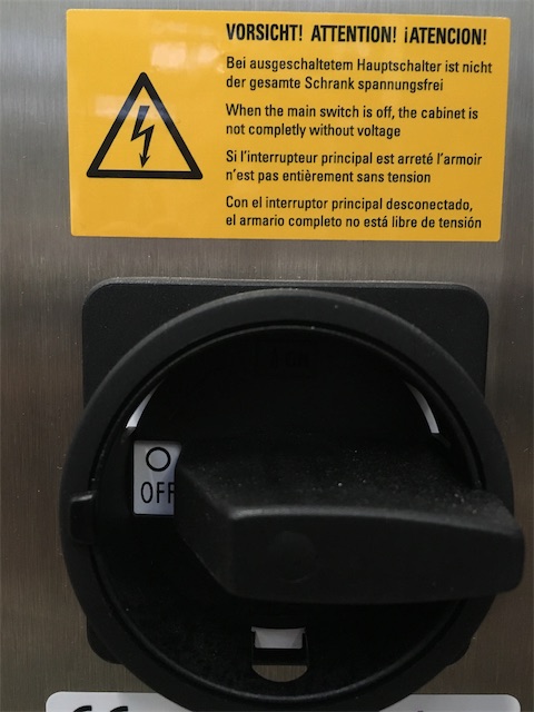 Warning sign above a main disconnect switch